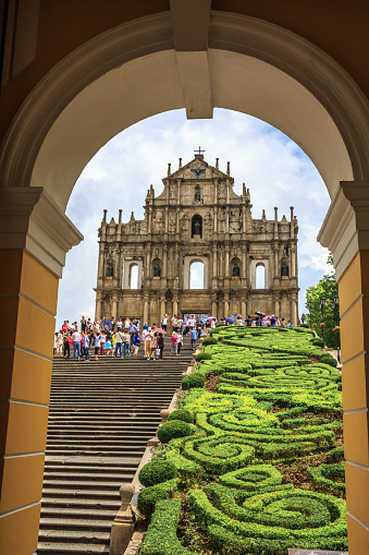 Macao, China - June 1, 2015: Tourists are taking pictures at the Ruins of St. Paul Cathedral during the raining day.