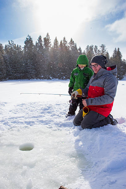 Mixed race family ice fishing Mixed race family ice fishingMixed race family ice fishing man ice fishing stock pictures, royalty-free photos & images