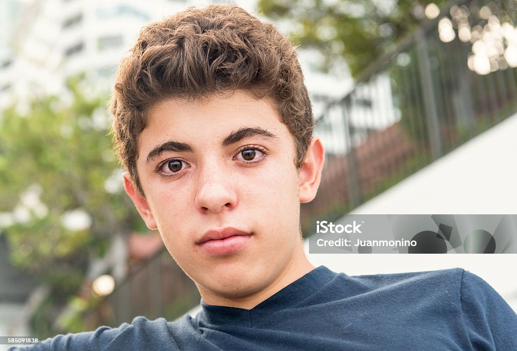 Pensive Teenager Pensive Israeli teenage boy looking at the camera Outdoors Stock Photo