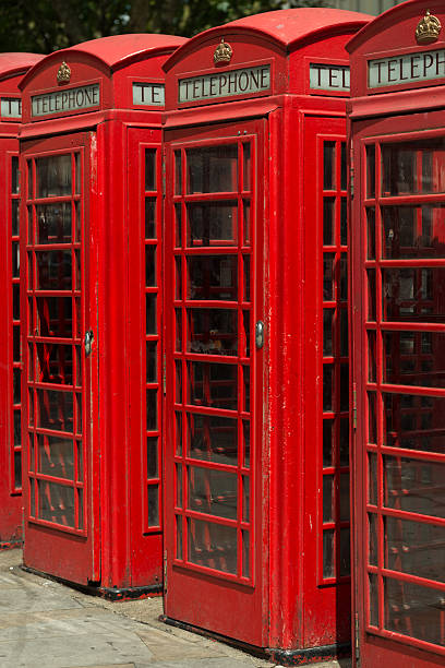 London Phone Booth London, USA - June 24, 2016: Red London phone booths late in the day in Trafalgar Square. british telecom photos stock pictures, royalty-free photos & images