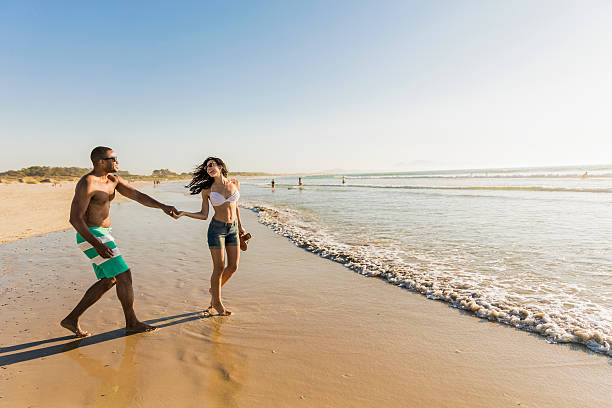 istock Happy young couple enjoying on sea shore 585093208