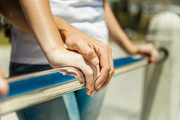 istock Midsection of couple holding hands on railing 585093418