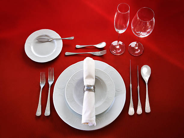 Table setting on red background Perfect table setting on red cloth background formal dinning stock pictures, royalty-free photos & images