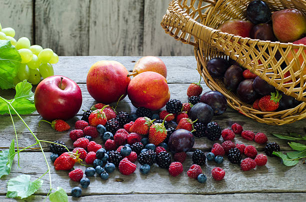 istock Berries, summer fruit on wooden table. healthy lifestyle concept. 585093716