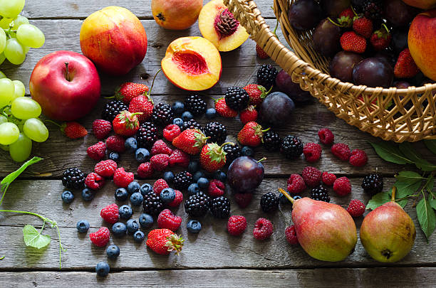 istock Berries, summer fruit on wooden table. healthy lifestyle concept. 585093882