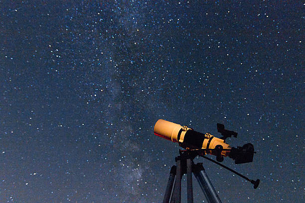 istock Telescope in real night sky. Refractor type. telescope 585093960