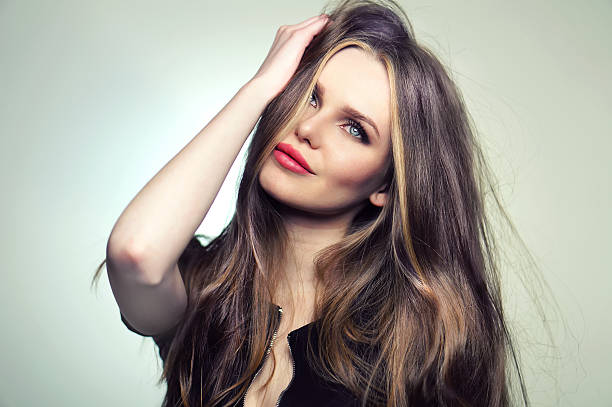 istock Young and emotional woman model posing at studio. 585146784