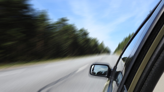 Car driving on freeway on lonely road, motion blur