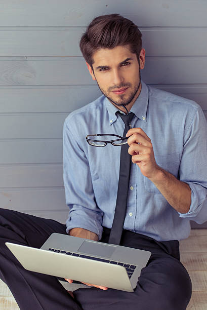 istock Handsome young businessman with gadget 585150742