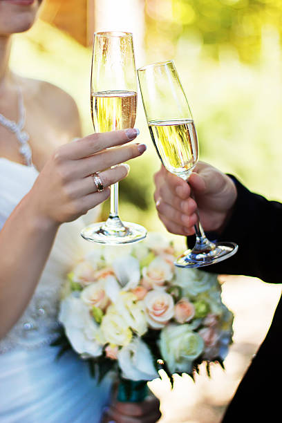 istock Bride and groom clinking glasses on wedding-day. 585151866