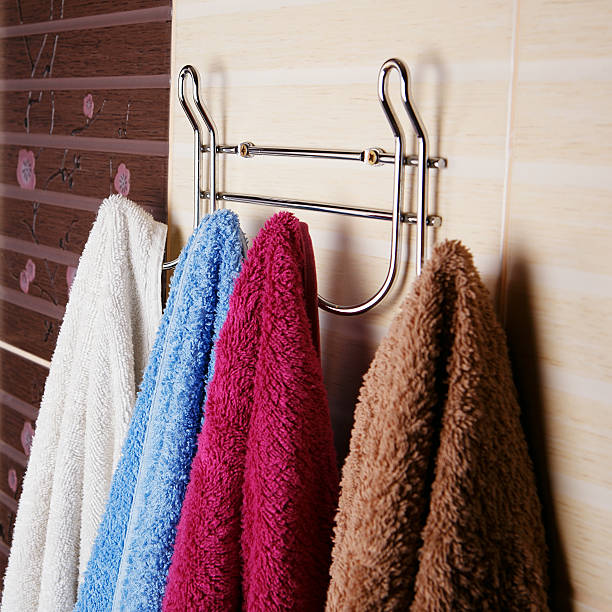 istock colored towels hanging on the rack in the bathroom. 585153680