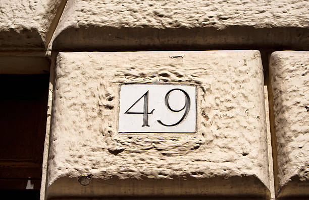 istock Engraved old building number 49 in Rome 585154128