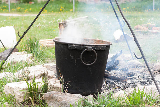 istock Pot water on hot campfire. Camping photo. 585156976