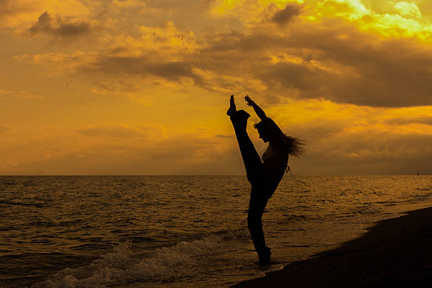 istock Young girl training on the beach 585157446