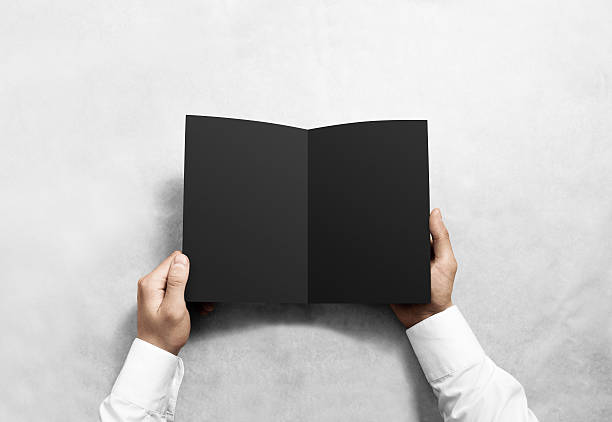 istock Hand opening blank black brochure booklet mockup. 585157732