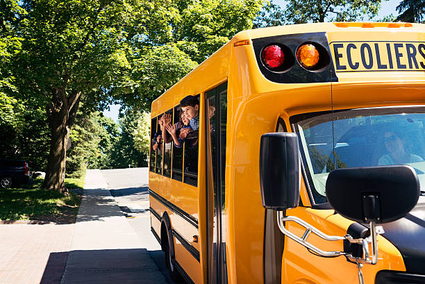 istock Group of elementary age kids on a yellow school bus. 585158410