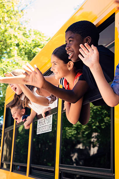 istock Group of elementary age kids on a yellow school bus. 585158526
