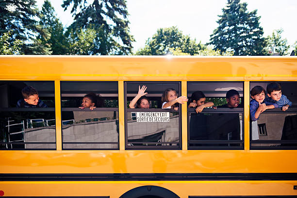 istock Group of elementary age kids on a yellow school bus. 585158864