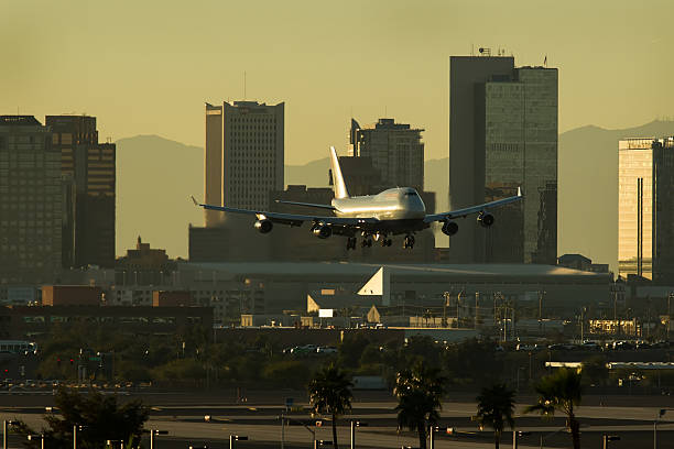 istock Jet plane descending into Sky Harbor Airport at Sunset. 585159114