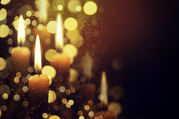 istock Candle with a flame brighter than the Christmas tree behind 585159958
