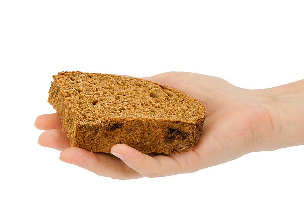 istock Female hand holds a slice of bread, isolated on white 585160186