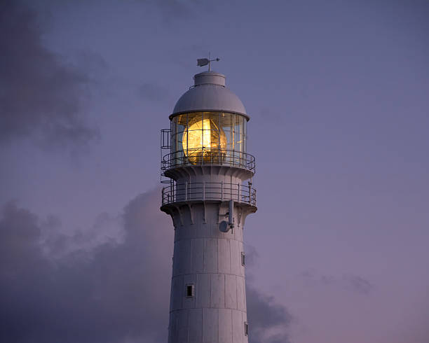 Sunset At The Lighthouse The day draws to a close with a beautiful sunset at Slangkop Lighthouse, Kommetjie, South Africa kommetjie stock pictures, royalty-free photos & images