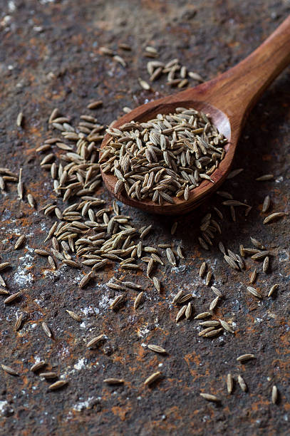istock Cumin seeds in wooden spoon 585161580
