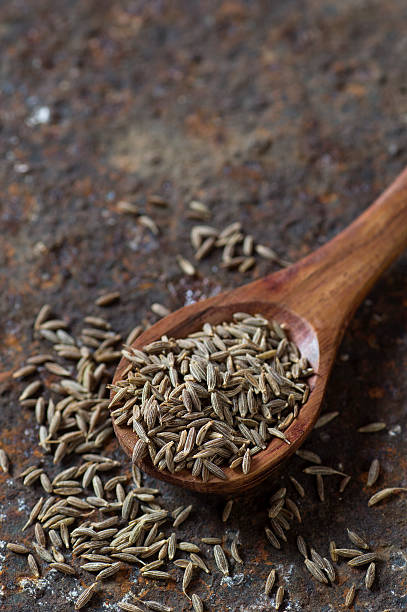 istock Cumin seeds in wooden spoon 585161668