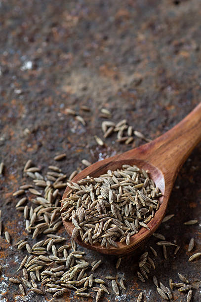 istock Cumin seeds in wooden spoon 585161714