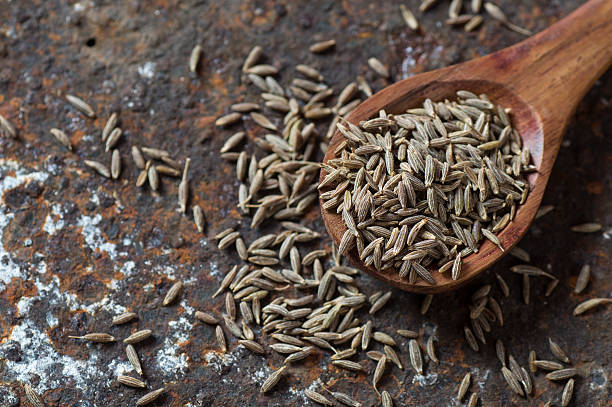 istock Cumin seeds in wooden spoon 585161756