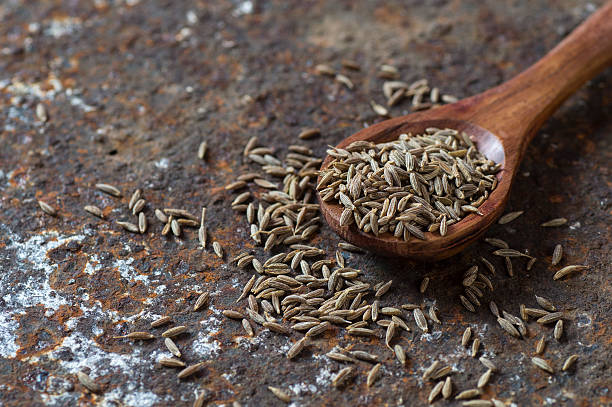 istock Cumin seeds in wooden spoon 585161812