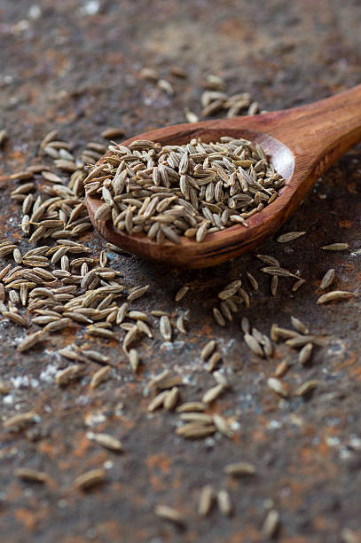 istock Cumin seeds in wooden spoon 585161866