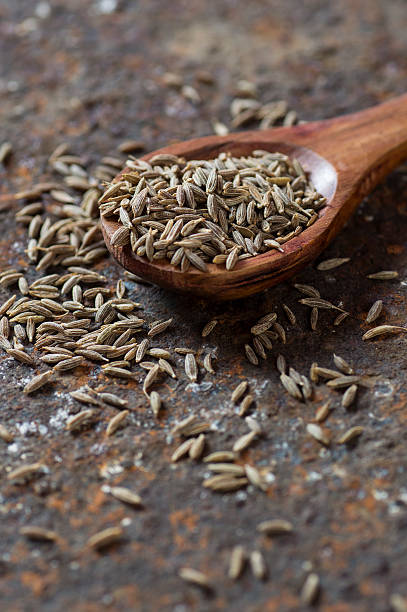 istock Cumin seeds in wooden spoon 585161910