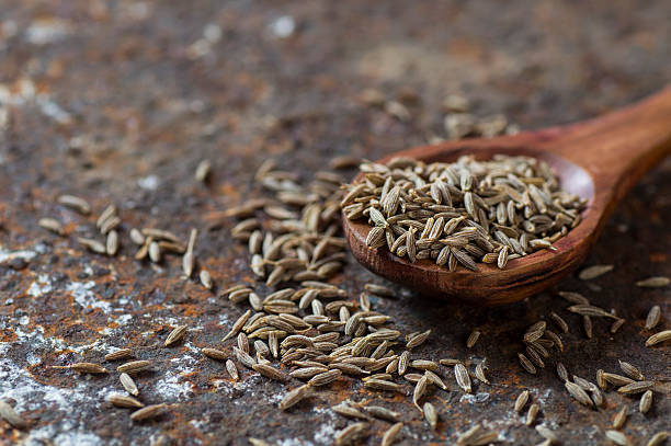 istock Cumin seeds in wooden spoon 585161964