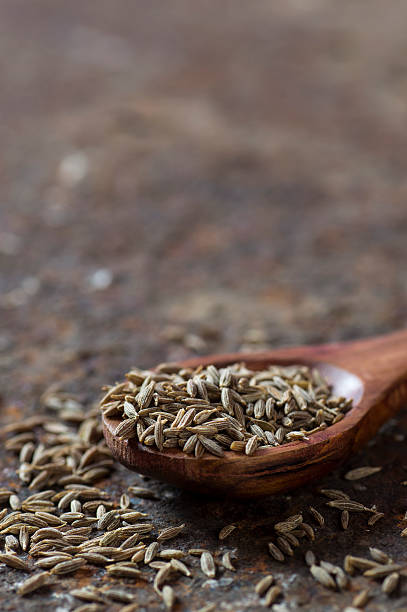istock Cumin seeds in wooden spoon 585162006