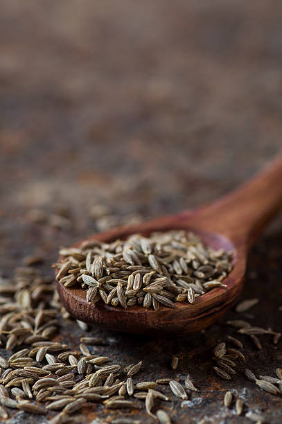 istock Cumin seeds in wooden spoon 585162050