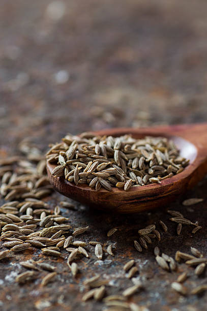 istock Cumin seeds in wooden spoon 585162102