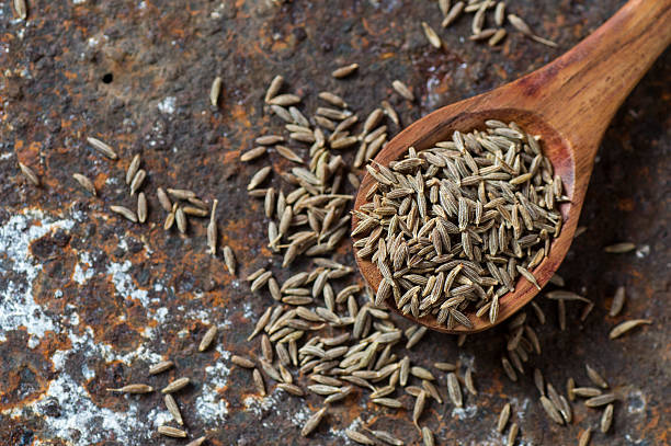 istock Cumin seeds in wooden spoon 585162154