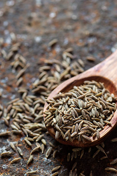 istock Cumin seeds in wooden spoon 585162208