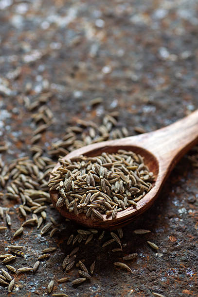 istock Cumin seeds in wooden spoon 585162246