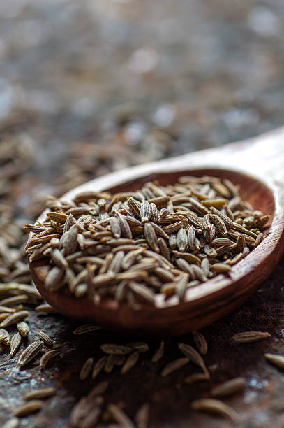istock Cumin seeds in wooden spoon 585162282