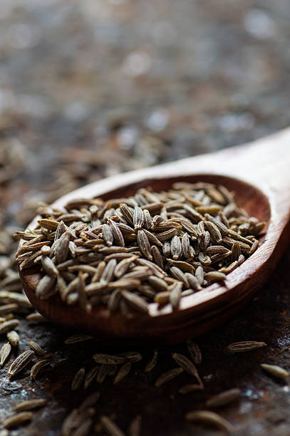 istock Cumin seeds in wooden spoon 585162318