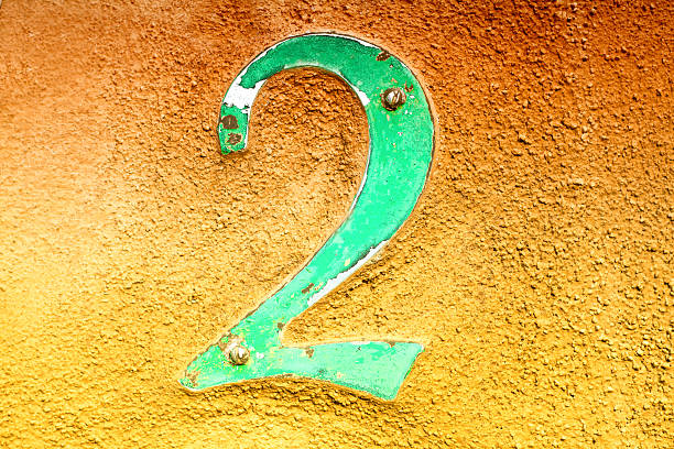 istock Number 2 Address Yellow-Orange Stucco Wall 585164024