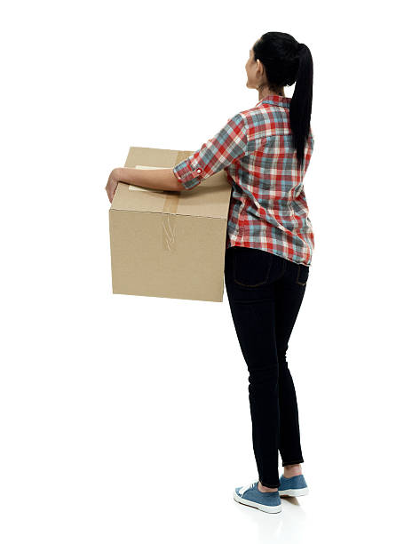 istock Rear view of female holding box 585164856