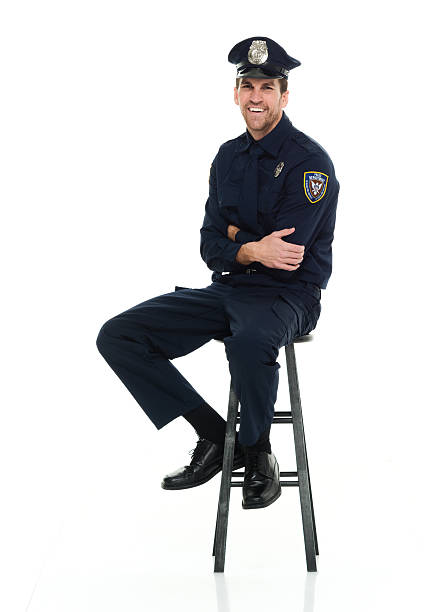 istock Smiling police sitting on stool 585170084