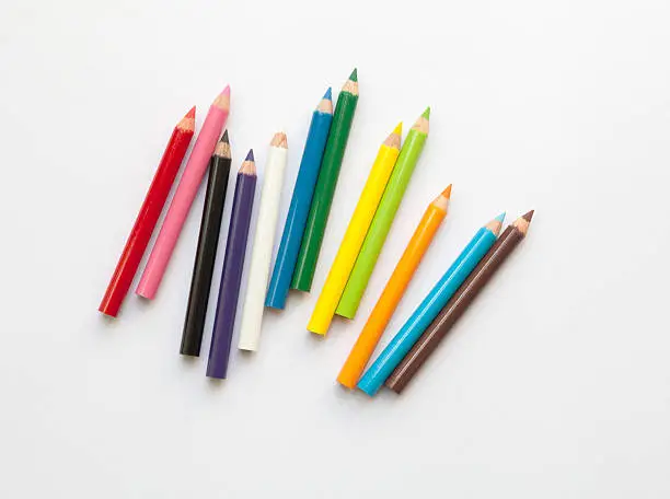 Photo of Bunch of fun mini colored pencils isolated on white