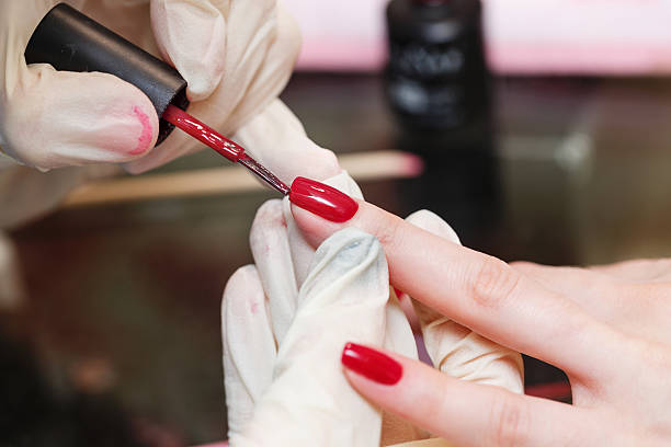 istock Manicure. Covering nail varnish color. 585171676