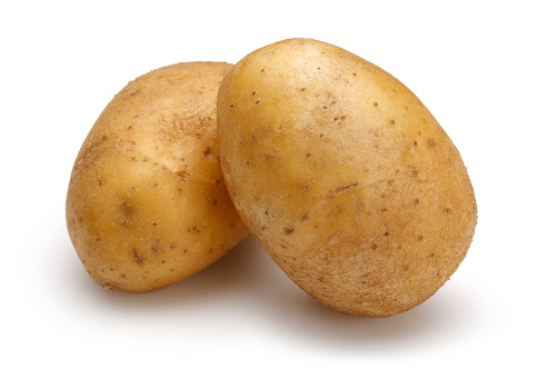 Flying vegetables. Unpeeled potato wedges with peel isolated on white background. The concept of not healthy eating or obesity from potatoes. To be inserted into a design or project