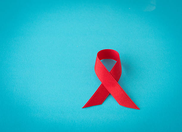 ruban rouge  - aids awareness ribbon photos et images de collection