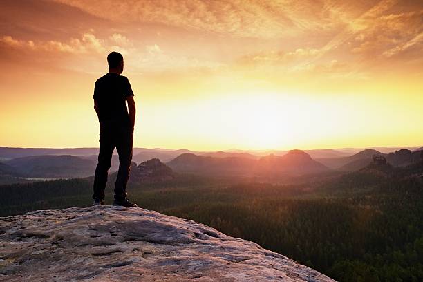istock Tall hiker has hands on hips. Thinking silhouette in nature 585174286